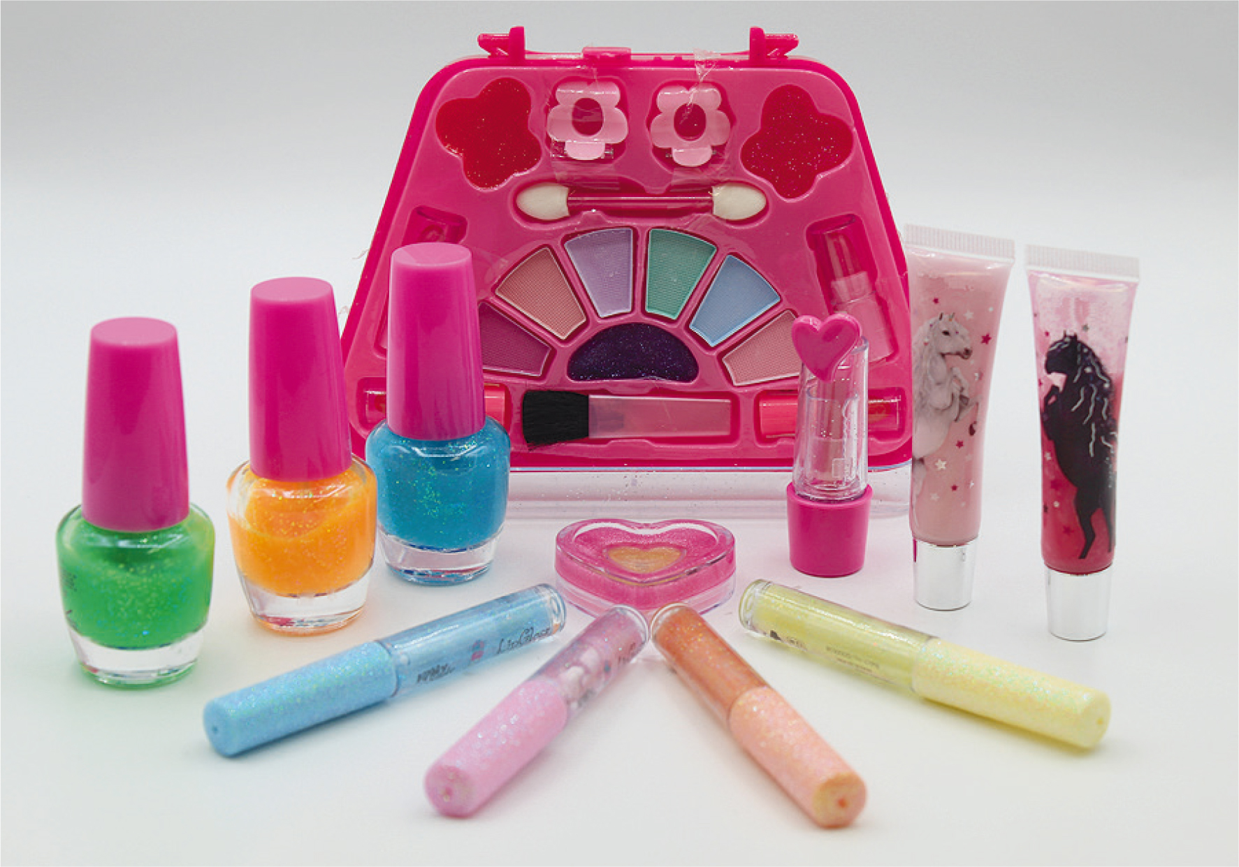 Verschiedene glitzernde Kinderkosmetikprodukte: Lidschatten, Nagellack, Gloss und andere